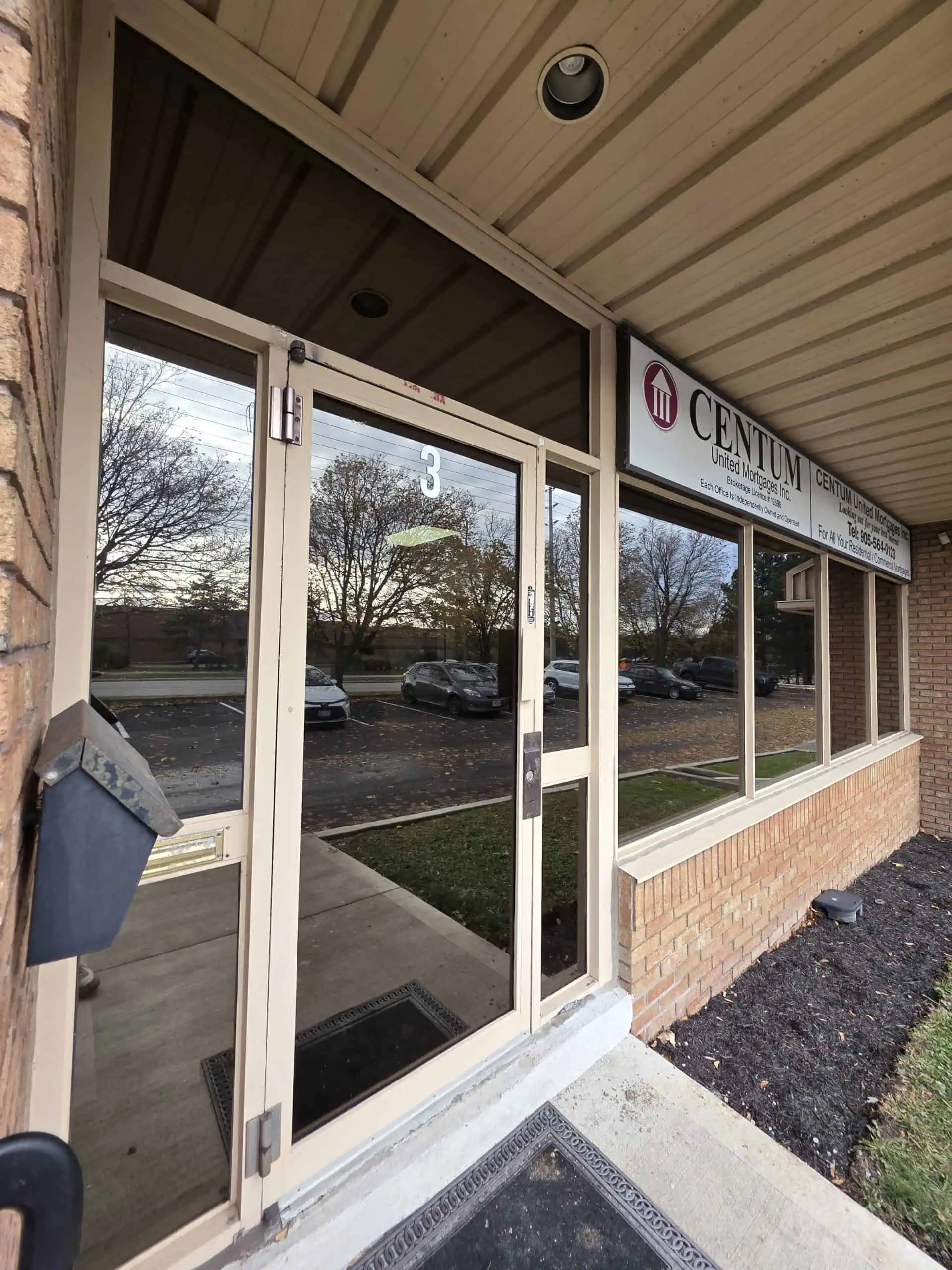 Film Bros installer applying security film to Burlington property window