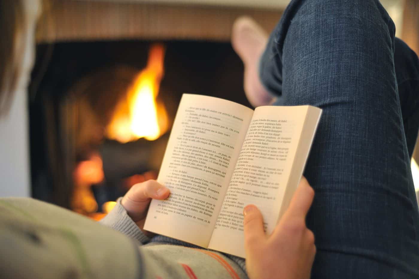 Refugio con libro y chimenea, ambiente acogedor para la lectura y la reflexión filosófica.