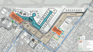 An aerial master plan of an airport, showing a teal-colored terminal building, orange rental car centers, light brown parking lots, and surrounding roads with proposed traffic signals and property acquisitions.