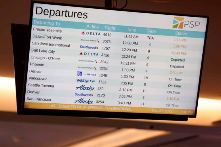 A digital airport departures board displaying flight information for Palm Springs International Airport (PSP) on May 27, 2025.