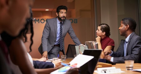 businessman-addressing-team-boardroom-meeting-close-up 1 businessman-addressing-team-boardroom-meeting-close-up 1