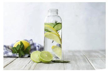 Fresh lemon and lime infused water in a glass jar with herbs and fruit slices for healthy hydration.