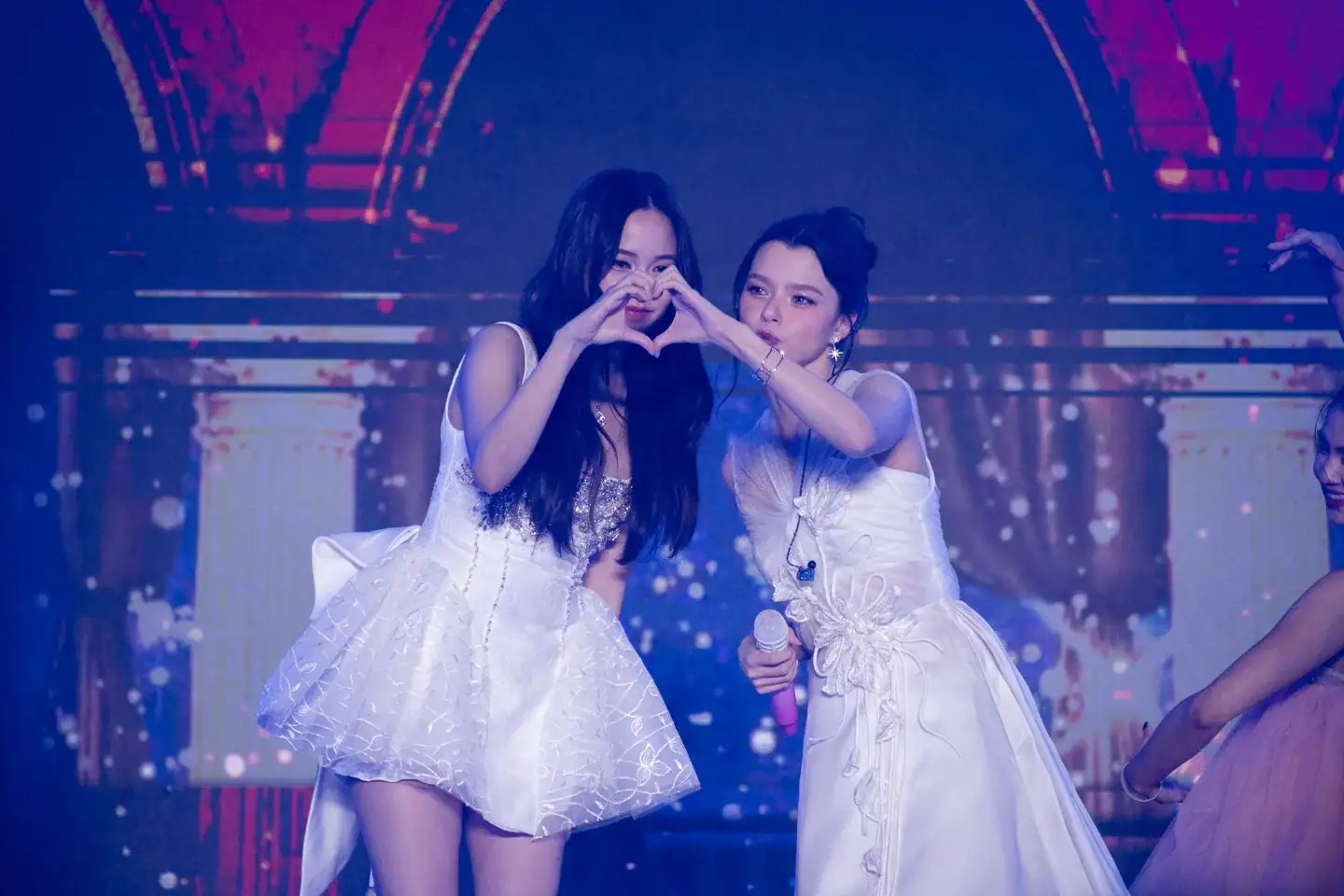 Freen Sarocha and Becky Armstrong making a heart with their hands on stage at CentralWorld Bangkok Countdown 2026