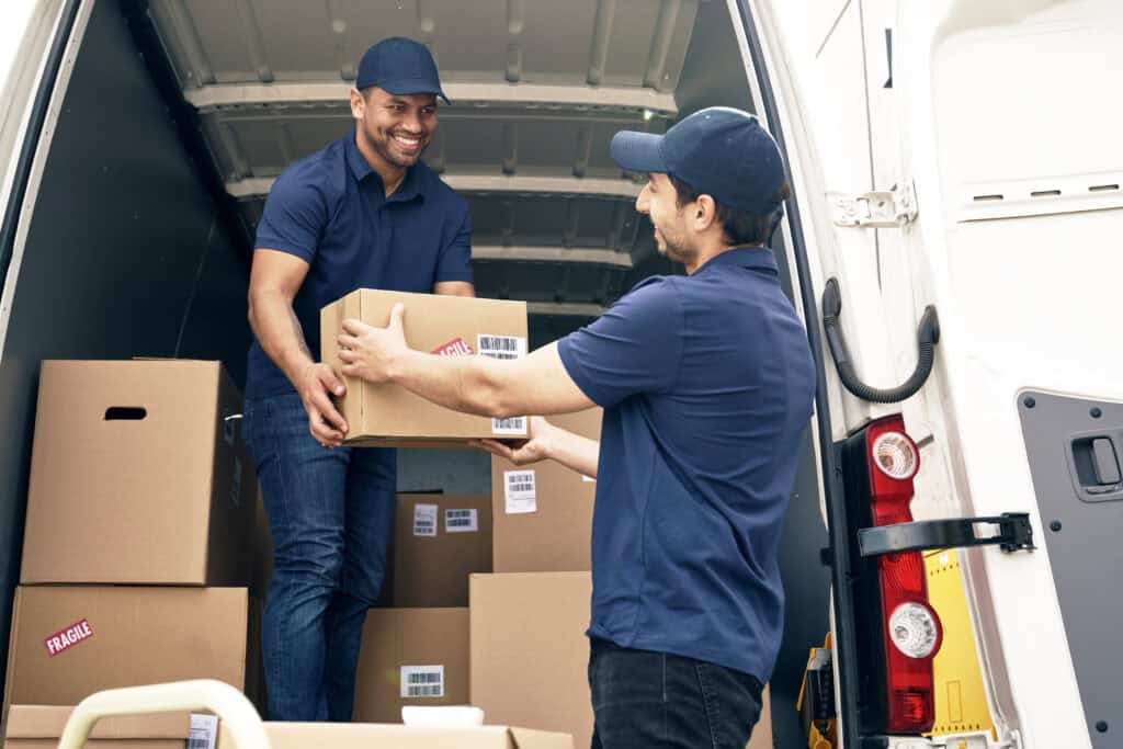 two happy couriers unloading packages from the car 2024 12 05 18 55 57 utc Home