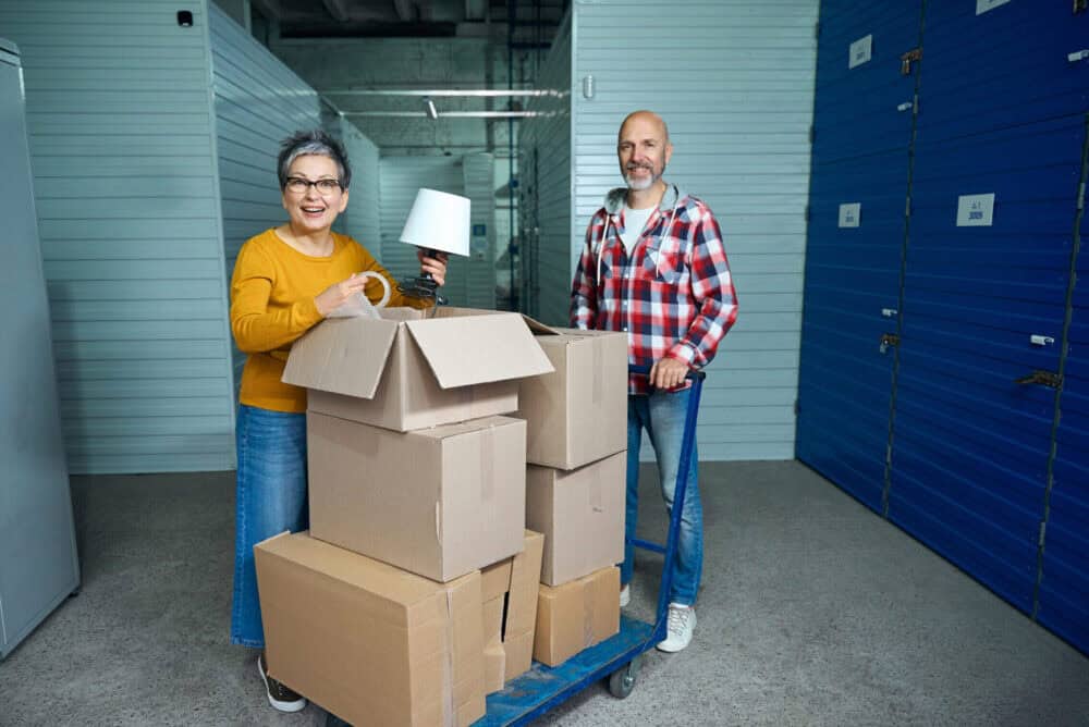 two people next to cardboard moving boxes 2025 03 05 04 44 10 utc scaled e1763251700897 Home