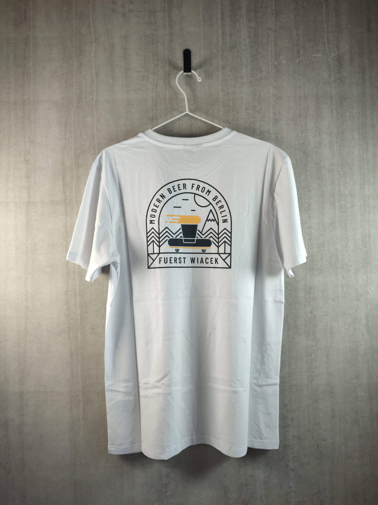 Vintage FUERST WIACEK Brewery t-shirt featuring modern beer from Berlin design, displayed on a hanger against a textured wall. Perfect for beer enthusiasts and fans of craft breweries.