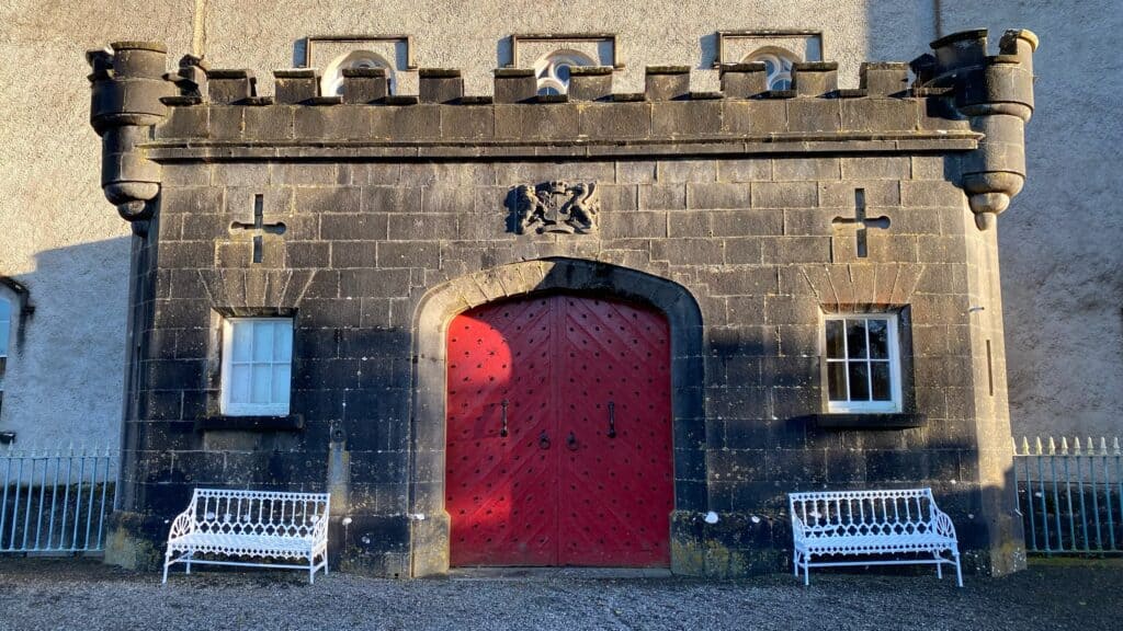 Stone castle gate with red door