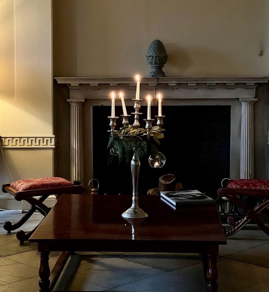 Elegant fireplace with candlelit table.