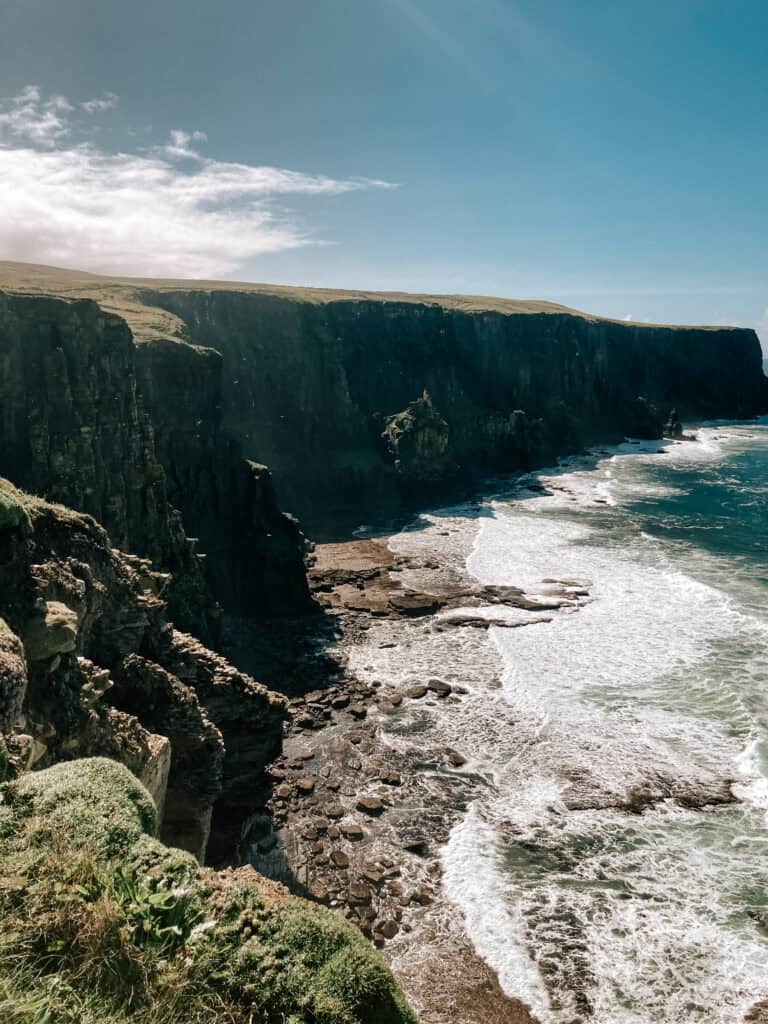 Majestic cliffs overlooking crashing waves.