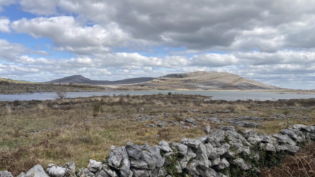 Rocky terrain with distant hills and clouds