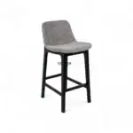Modern upholstered bar stool with black wooden legs, comfortable fabric seat.