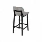 Contemporary upholstered bar stool with black wooden legs for modern kitchen decor.