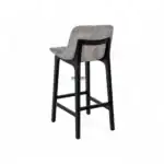 Contemporary upholstered bar stool with black wooden frame and neutral fabric seat.