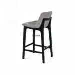Contemporary upholstered dining chair with wooden frame for modern home decor.