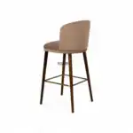 Modern upholstered bar stool with wooden legs and brass footrest, ideal for stylish kitchen or bar area.