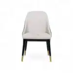 Sleek white modern dining chair with black and gold tipped legs, stylish and comfortable furniture piece.