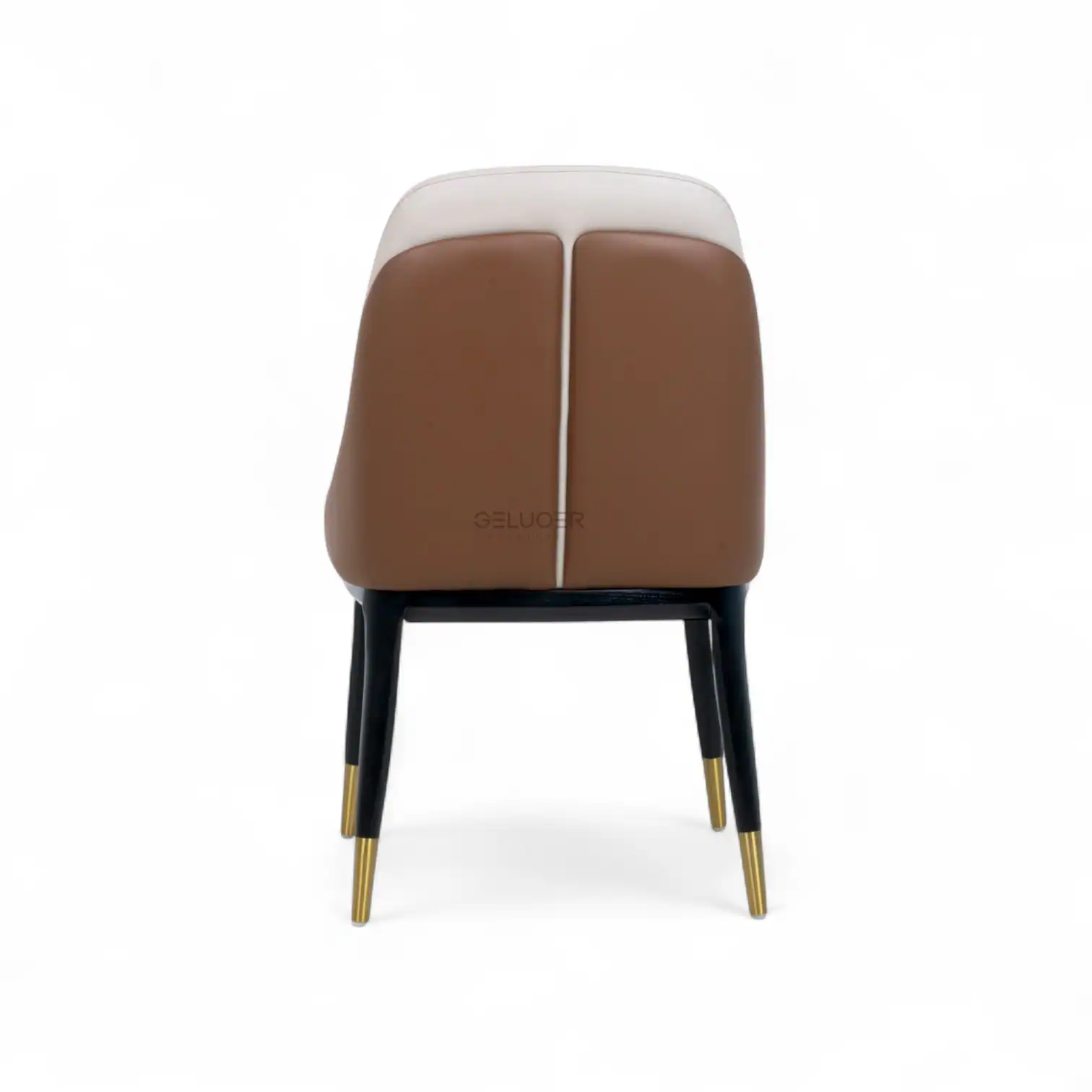 Sofa with tan and white leather upholstery on black and gold legs, modern stylish furniture piece.