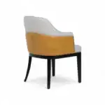 Sofa chair with white and mustard leather upholstery and black wooden legs.