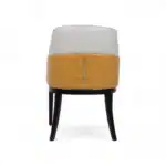 Comfortable modern accent chair with white and mustard yellow upholstery and black wooden legs.