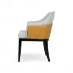 Sleek modern lounge chair with white and tan leather upholstery, wooden black legs, stylish furniture design.