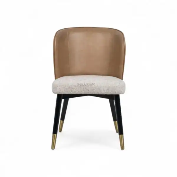 Luxurious modern dining chair with leather and fabric upholstery, gold-tipped legs, ideal for contemporary interior design.