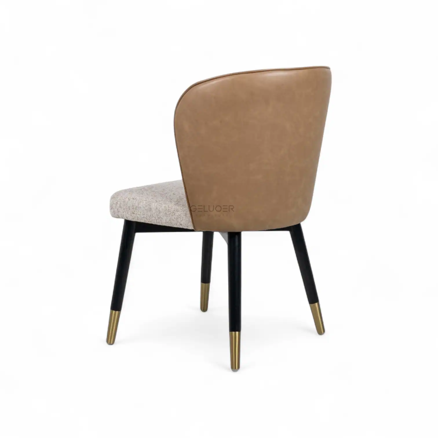 Luxurious modern accent chair with leather backrest and upholstered seat, stylish gold-tipped black legs.