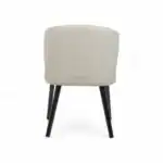 Elegant modern accent chair with curved beige upholstery and black wooden legs for stylish home decor.