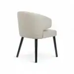 Contemporary beige upholstered accent chair with black wooden legs, modern furniture design.