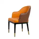 Luxurious orange and brown leather accent chair with black and gold legs - modern furniture design.