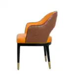 Elegant leather accent chair with quilted backrest and gold-tipped legs, modern furniture for living room or office decor.