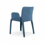 Blue velvet upholstered modern dining chair with sleek wooden legs.