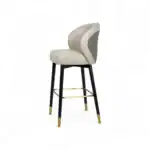 Luxury modern dining chair with beige leather upholstery and black wooden legs.