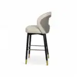 Luxury modern high-back bar stool with quilted leather upholstery and gold-accented legs.