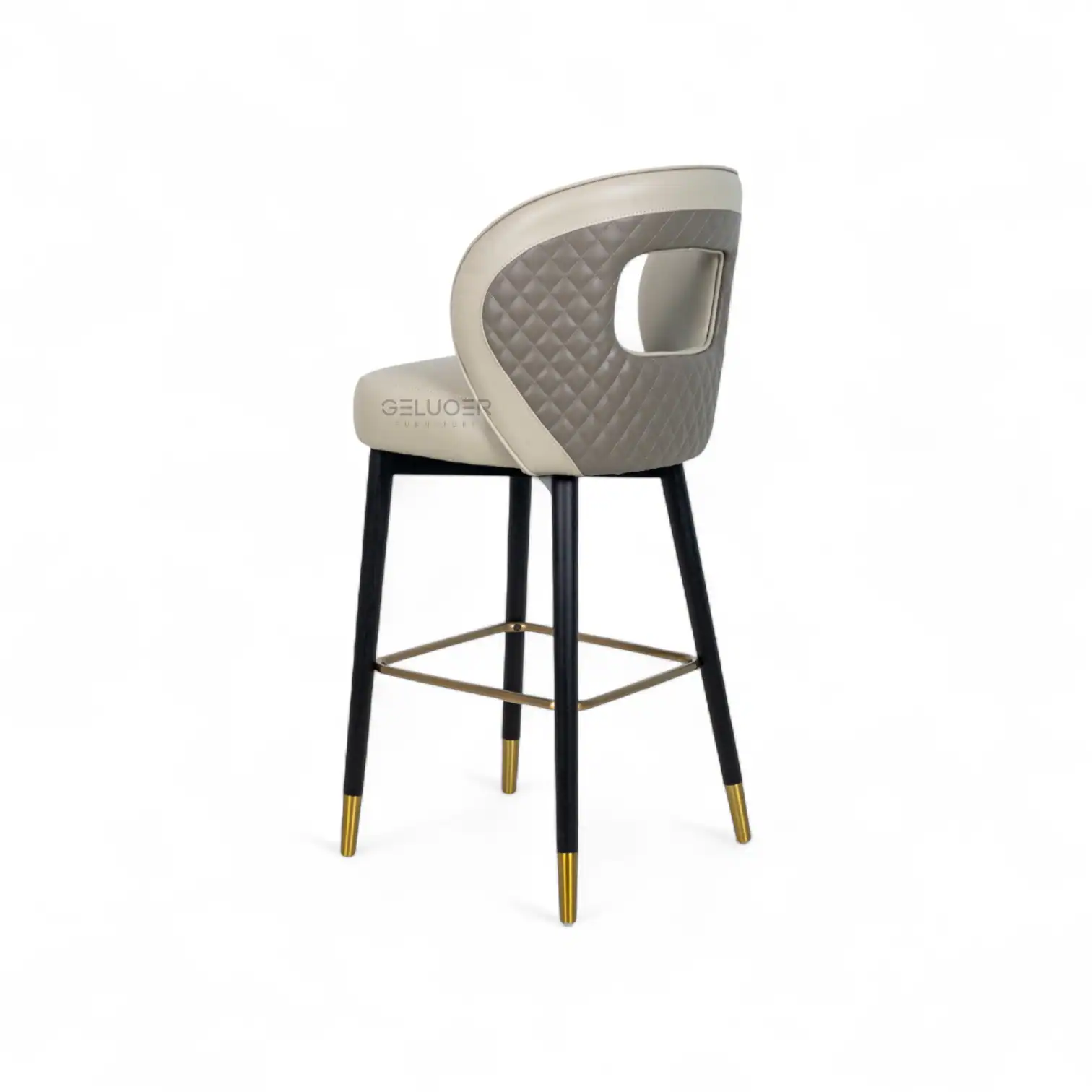 Luxurious beige and gray upholstered bar stool with quilted backrest and gold-accented black wooden legs.