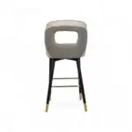 Luxury modern bar stool with quilted gray upholstery and black gold-accented wooden legs.