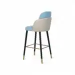 Gray and blue modern upholstered bar stool with gold accents and black legs.
