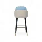 Modern upholstered bar stool with black wooden legs and gold accents.