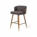 Contemporary brown leather-upholstered bar stool with wooden legs and gold accents.