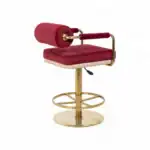 Luxurious red velvet office chair with gold accents and adjustable height for modern workspace comfort.