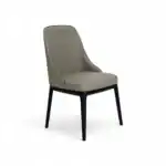 Luxurious beige upholstered dining chair with black wooden legs, perfect for modern interior decor.
