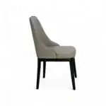 Elegant beige quilted leather dining chair with black wooden legs, perfect for modern interiors.