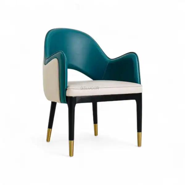 Modern armchair with a teal and cream leather finish featuring gold-tipped legs.
