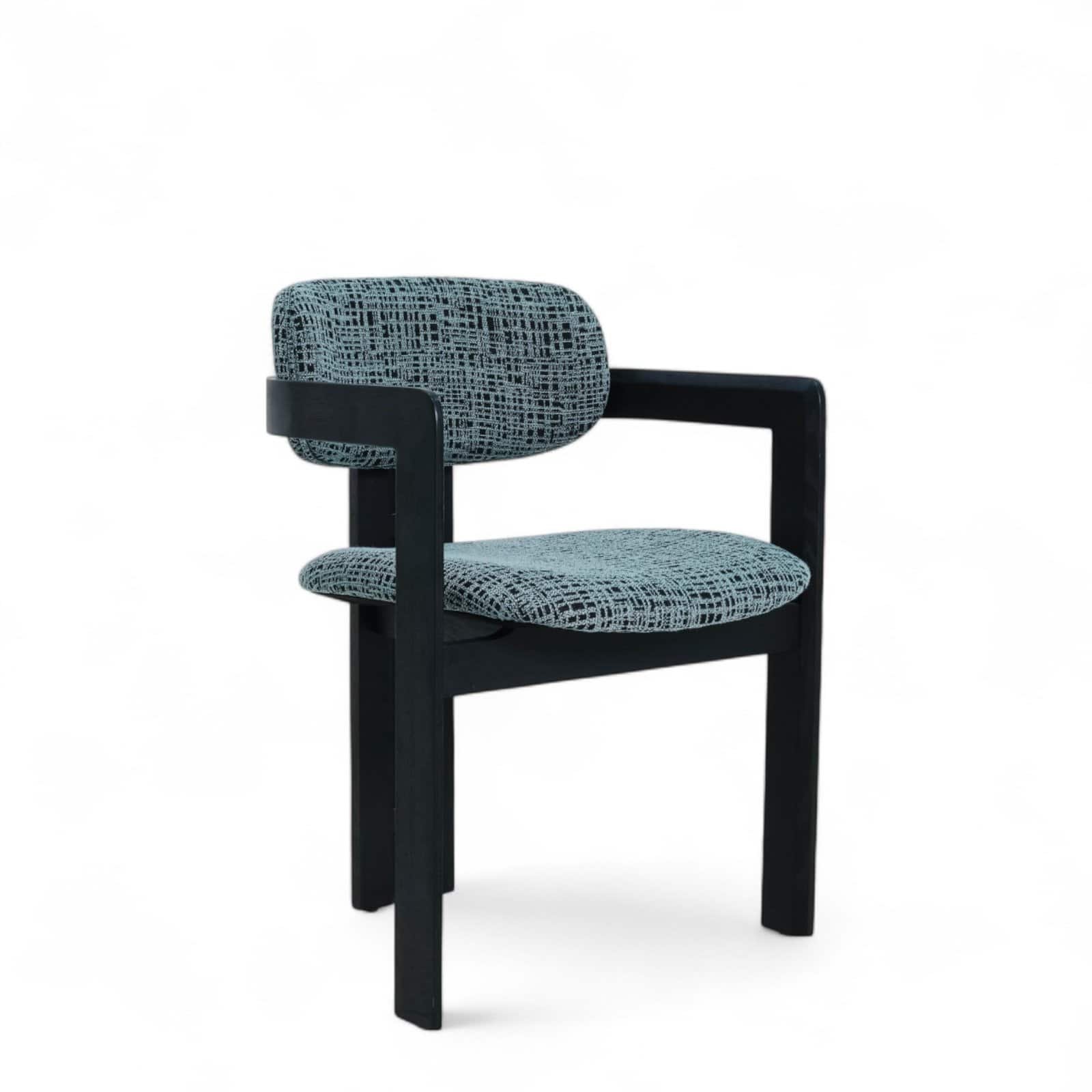 Stylish modern armchair with black wooden frame and patterned fabric upholstery.