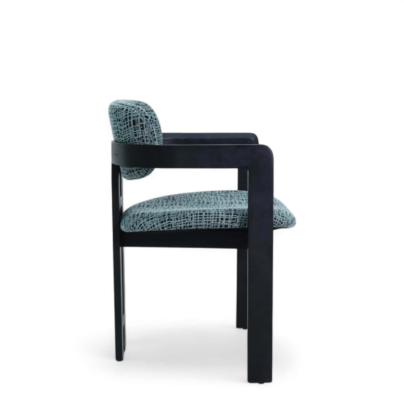 Black wooden frame armchair with patterned fabric upholstery.