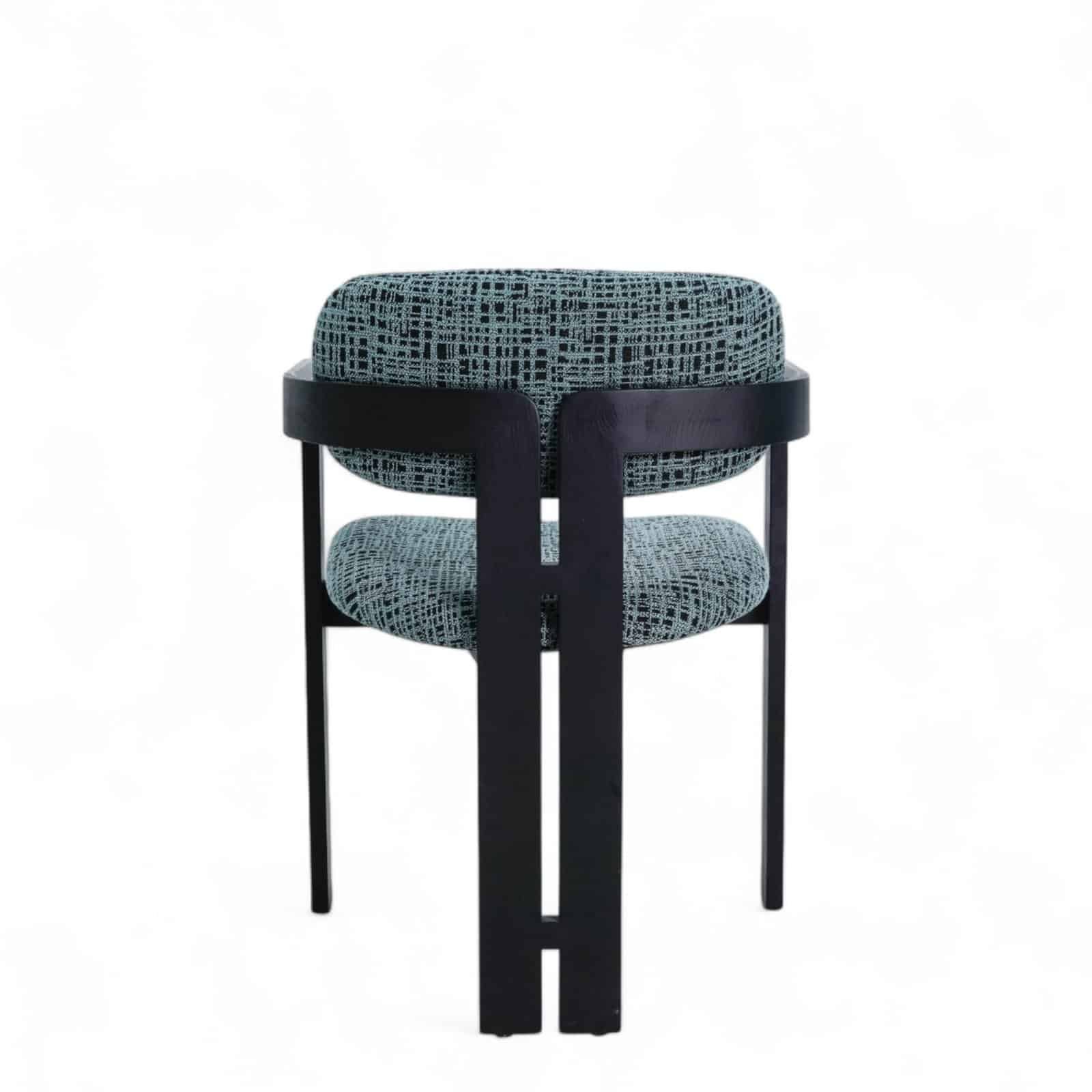 Elegant modern armchair with geometric patterned upholstery and black wooden frame for stylish living spaces.