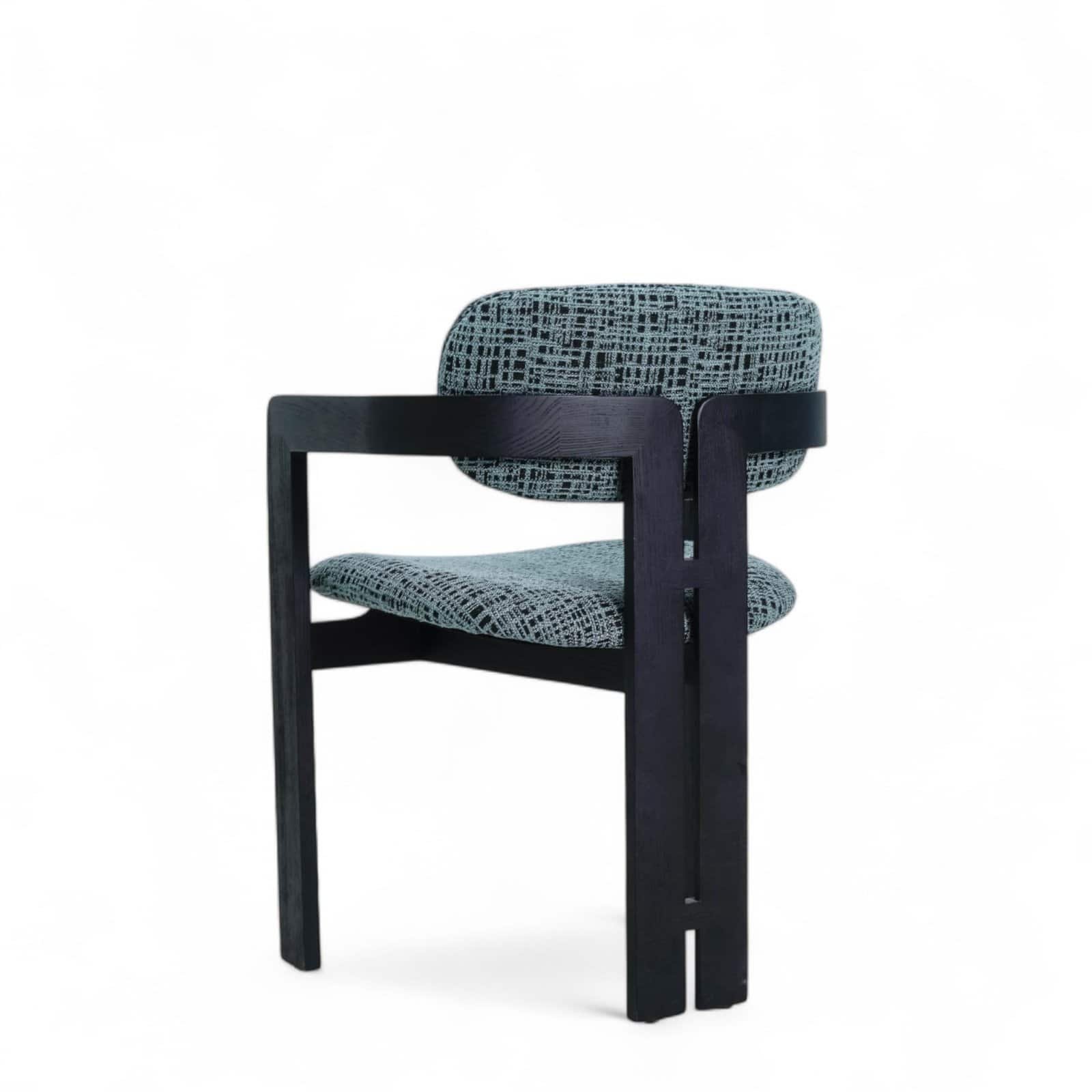 Contemporary modern armchair with black wood frame and fabric upholstery, stylish furniture for living room or office.