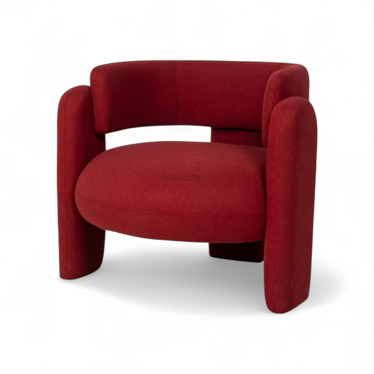 Plush red velvet modern armchair with curved arms, perfect for contemporary living spaces.