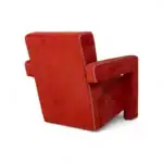 Luxurious red velvet armchair with white stitching - perfect for modern home decor.