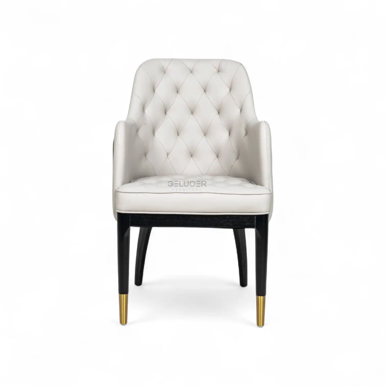 Luxurious white upholstered armchair with tufted back, black legs, and gold accents, perfect for elegant home decor.
