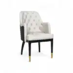 Elegant white quilted accent chair with black wooden legs and gold-tipped feet, stylishly designed for luxury furniture décor.